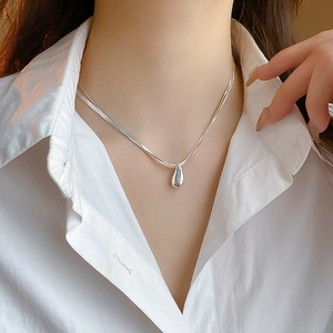Silver metal teardrop pendant double layer necklace on model with white shirt