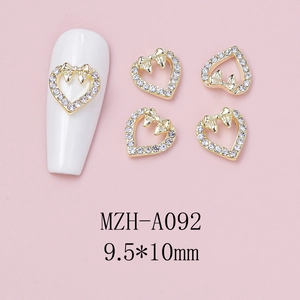 Detail of heart nail charms with gold bows and rhinestones, size 9.5x10mm model MZH-A092