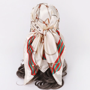 Close-up of vintage chain pattern satin headscarf tied on hair model in retro style