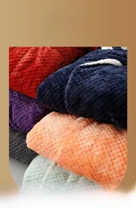 Close-up of thick waffle pattern flannel robes in multiple colors including navy and burgundy