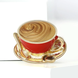 Exquisite red and gold enamel coffee cup brooch with golden spoon on a white background