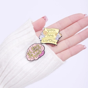 Enamel daisy pins featuring 'You Are Worthy' and 'Be Kind To Your Mind' motivational quotes
