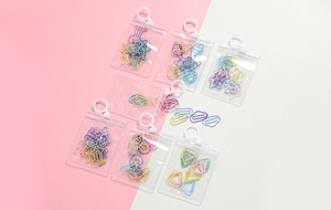 Detail of colorful shaped paperclips including clouds and stars in zipper bags