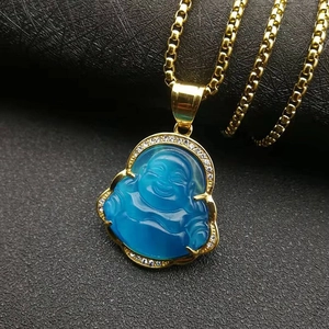 Detail of gold plated stainless steel necklace with blue stone Buddha pendant