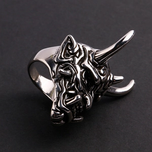 Macro side view of stainless steel devil mask ring with detailed gothic relief