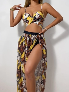 Detailed view of women's three-piece bikini set with tropical leaf print mesh long skirt