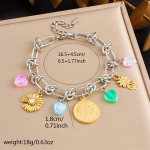Detail of multi-element charm bracelet with colorful hearts and floral motifs