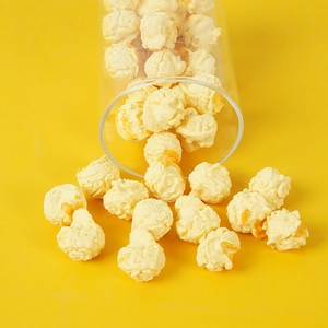 Realistic PVC popcorn model spilling from glass jar against vibrant yellow background