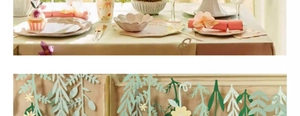 Detail of floral party banners and matching pastel paper tableware for festive window display