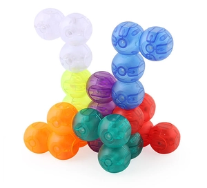 Detailed macro shot of translucent magnetic building spheres in various vibrant colors