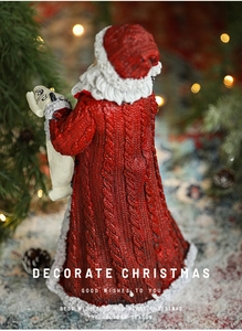 Detailed back view of a resin Santa Claus figurine with knit texture holding a polar bear