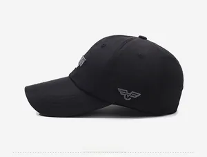 Close-up of black baseball cap featuring gray wing embroidery and premium twill fabric