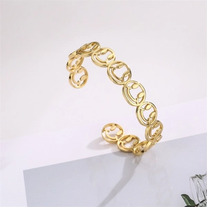 Detail of gold-plated smile hollow-out bangle with micro-pave cubic zirconia on gray background