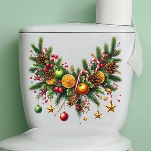 Detail of Christmas wall sticker with pine branches and berries on a white surface