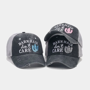 Detailed embroidery of BARN HAIR DON'T CARE slogan on washed mesh ponytail baseball cap