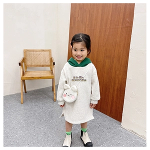 Detailed view of the cute white plush rabbit crossbody bag on a girls' hooded dress