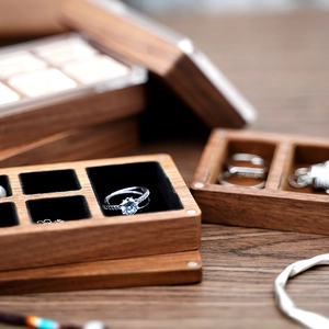 Macro shot of walnut wood jewelry box with magnetic closure and black velvet lining
