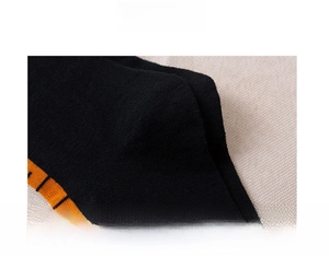Detail of reinforced toe and heel on black knitted chicken leg socks with orange stripes