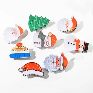 Christmas hair clips featuring Santa, snowman, and tree shapes in festive acrylic designs