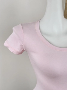 Close-up of the soft knit texture and ribbed neckline on this pink slim-fit t-shirt