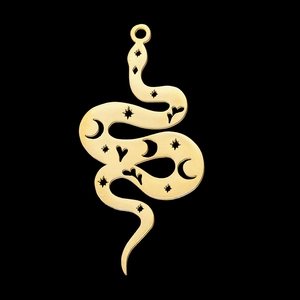 Detailed view of a gold snake pendant with star and moon hollow patterns on black background