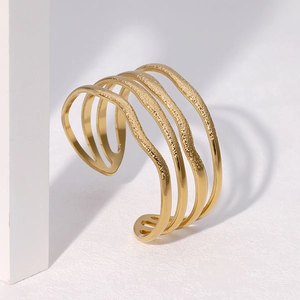 Wide gold plated stainless steel cuff bracelet with layered wavy hammered metal texture