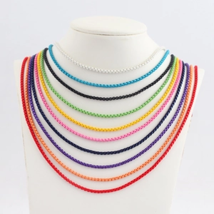 Close-up of colorful snake chains on a white mannequin featuring vibrant candy colors