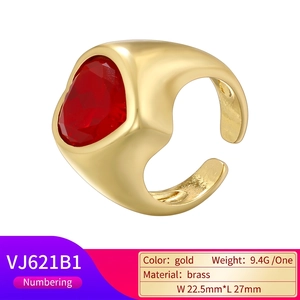 Vintage gold plated brass open ring featuring a large red heart shaped faceted gemstone
