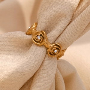 Detailed macro view of 18K gold plated stainless steel ring with rose flower patterns