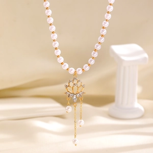 Vintage style faux pearl choker necklace with gold-toned lotus pendant and delicate tassel chains.
