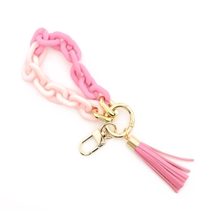 Detail of pink gradient acrylic wristlet keychain with leather tassel and gold clasp