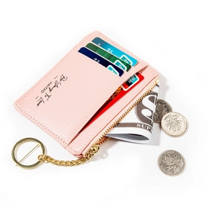 Detail view of pink leather card holder with gold zipper and keyring for keys