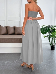 Back view of a grey strapless maxi dress featuring an elastic smocked bodice and flowing skirt