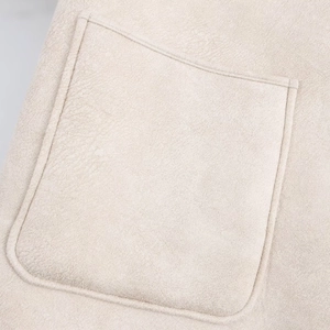 Close-up of the beige faux suede pocket with reinforced stitching on the jacket