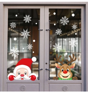 Christmas window stickers with Santa and reindeer displayed on a glass storefront door