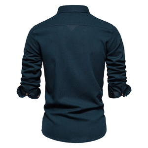 Detailed back view of a navy blue cotton long-sleeved shirt with folded cuffs on white background