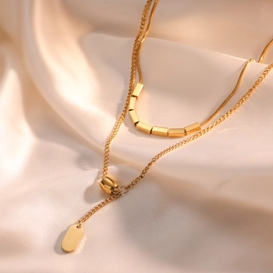 Minimalist double-layered gold-plated stainless steel necklace with cylinder charm pendants