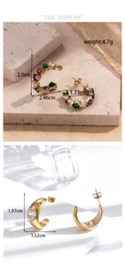 Detail view of C-shaped gold-plated earrings with colorful heart stones and zircon inlay