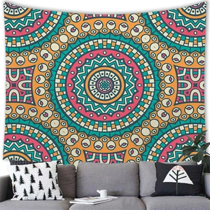 Detailed close-up of a bohemian mandala tapestry above a sofa in a cozy room