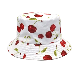 Détail du motif cerise rouge sur chapeau bob blanc avec coutures de bord résistantes