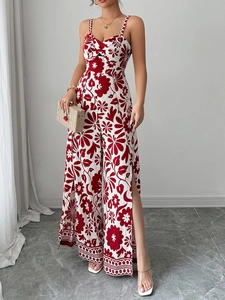 Detail of red floral print jumpsuit with knotted neckline and side slit wide leg design