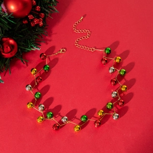 Detailed shot of Christmas bead necklace with colorful bells on bright red background