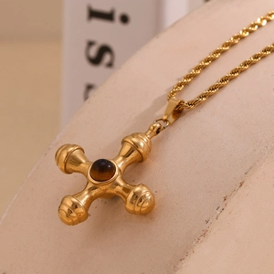 Detail showing the 18K gold plated rudder pendant and brown gemstone on twist chain