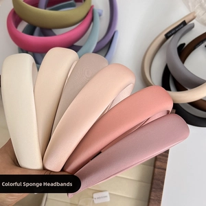 Detailed stack of various colored thick sponge headbands with soft matte fabric texture