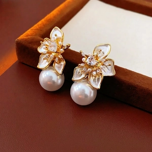 French vintage flower pearl earrings with gold plating and zircon inlay on a velvet tray