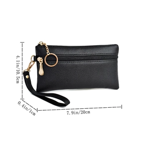 Detail view of black pebble leather wallet with zipper, wrist strap and dimension markings