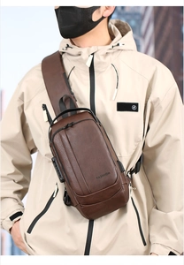 Detail of dark brown leather sling bag with security lock and integrated USB charging port