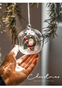 Detail of Christmas glass ball with miniature Santa Claus and snow scene ornament
