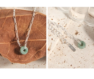 Detailed macro view of S925 sterling silver chain with a green jade round pendant