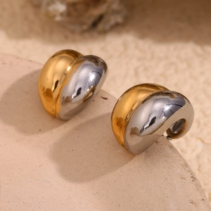 Macro shot of minimalist C-shaped 18K gold and silver plated stainless steel earrings